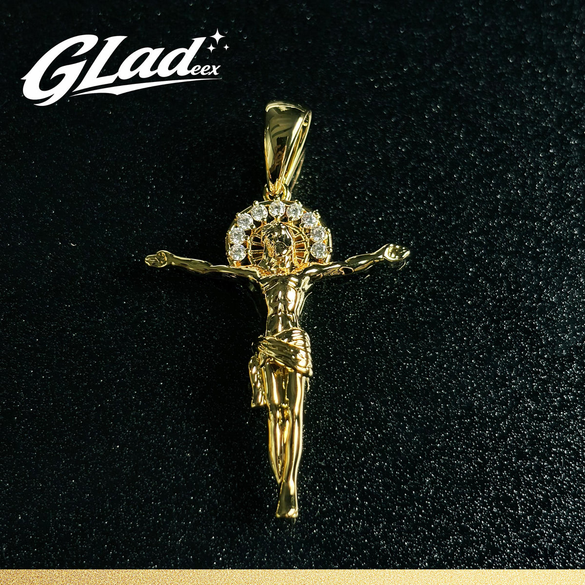 14K gold plated crucifix pendant with stone accents on a black surface