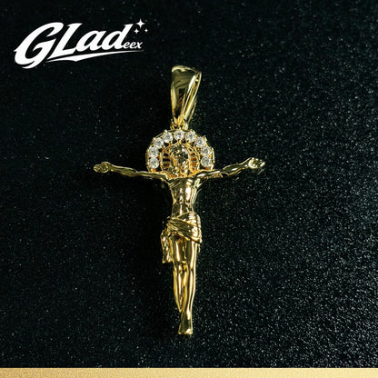 14K gold plated crucifix pendant with stone accents on a black surface