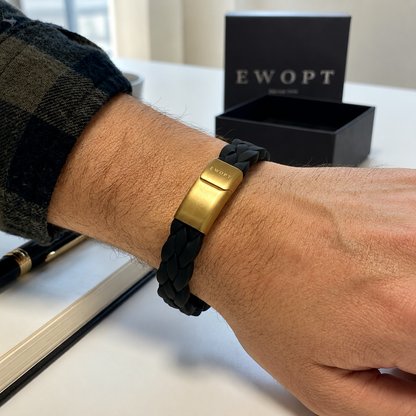 Man wearing a black silicone bracelet with a 14K gold plated clasp